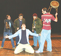 Cast members encourage Dave Wrathall (right) to clobber Christopher Alvarado with a stool after he gets to first in line in the one-act play Line.
