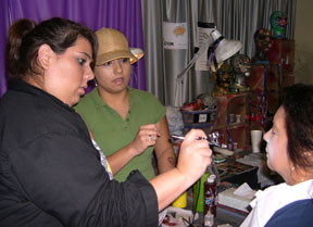 Taysha Lamarca, stage make-up artist student, works with former Cerritos College make-up student, Monica Caldera, who is now a employee of Knotts, with making a monster.