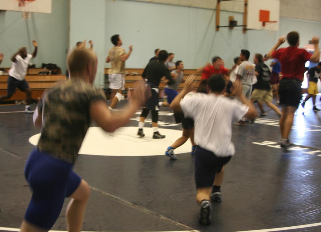 The wrestling team streching during one of its practices