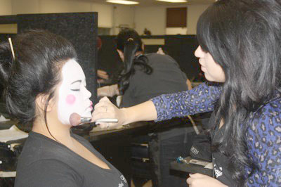 Krystal Martinez (right) is working on her client and fellow classmate, Teresa Angcaco, as she transforms Teresa from head to toe into a Geisha.