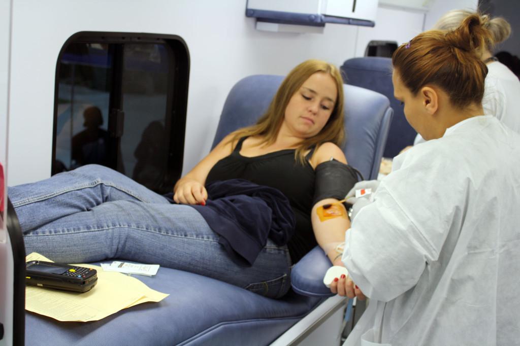 A nurses assistant (right) prepares to draw blood from administration of justice major, Kelly Willis (left).This was Willis first time donating blood.