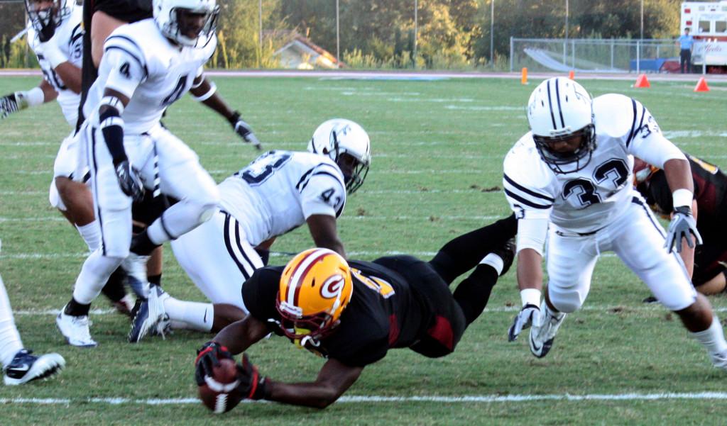 Saddleback College running back Donnell Dickerson (black jersey) dives into the endzone during the Gauchos 56-21 win over the Cerritos College football team. Dickerson had three touchdowns and 97 yards on 17 carries. 