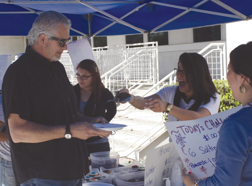 Cerritos College Multimedia Product Specialist Michael Wisniewski purchased a cookie from the iFalcon Club. The cookie costed $5 during the bakesale.