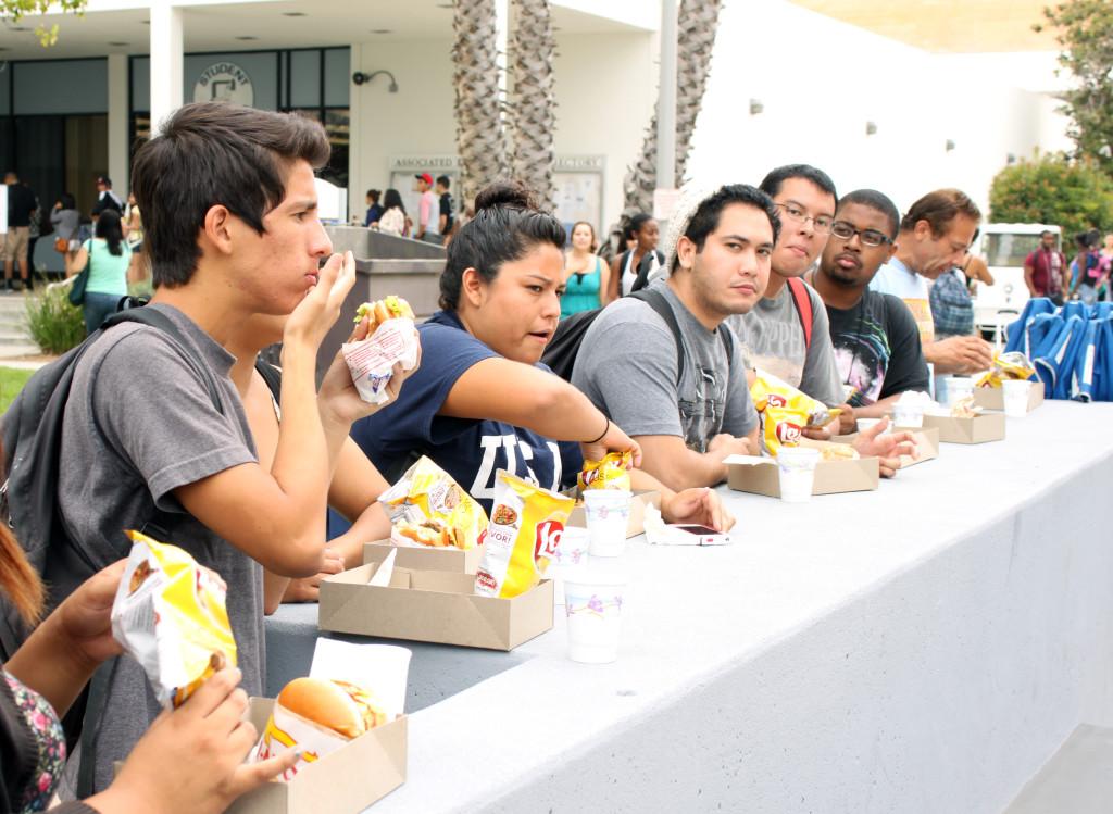 Students begin to eat after receiving their free In-N-Out hamburger. Approximately 780 people were served on Welcome Night and 960 people were served on Welcome Day.