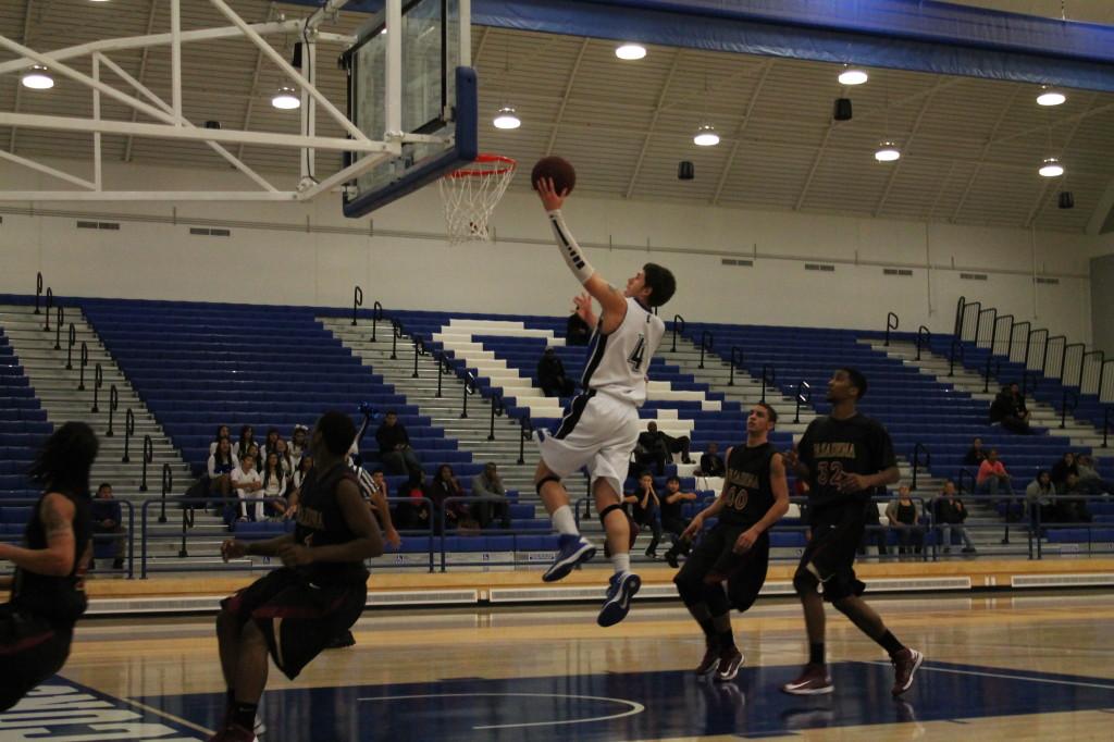 Freshman guard Kevin Conrad drives pass the Pasadena City College defense for a lay up. Conrad had 21 points, four rebounds, two assists and two steals on the night.