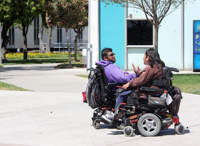 Pearl Netrayana, Child Developement Major, and Bhumit Shah, Business Major having a coversation on campus.