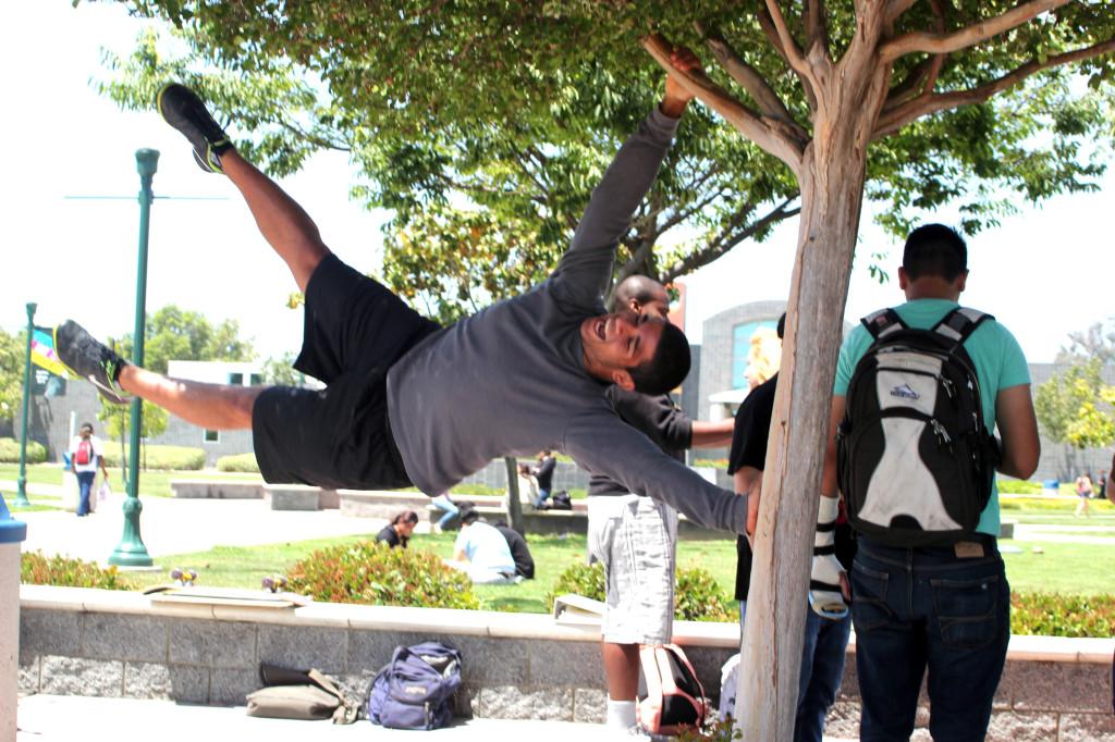 Exercise Science major Orlando Alfaro showcases his strength by acting as a human flag. Orlando competes under the cerritos name as he is in the wresting team and the triathlon club.