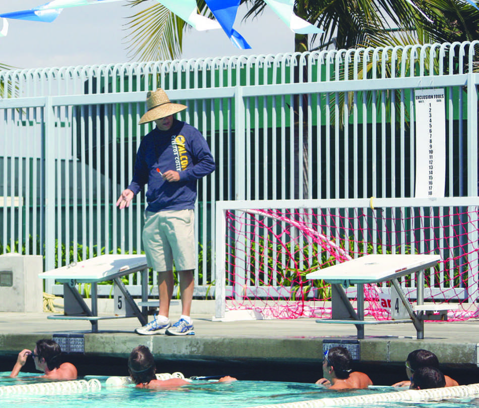 Joe Abing, coach of the mens swimming team, instructs his swimmers on what they are going to do during practice. Photo credit: Luis Guzman