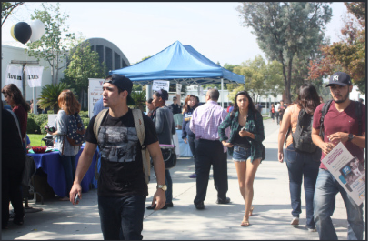 Fair:
Students walked down the library sidewalk during the Job Fair on Tuesday.
It was organzied by Career Services, hosting companies like Chipotle and FedEx. 