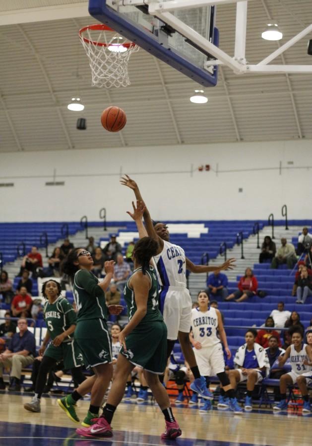 Kennedi Cooper, guard, jumps high enough for a pass to tip the ball in the basket.