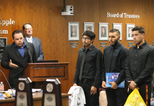 Men's soccer head coach Benny Artiaga (left) recognizing his roster and coaching staff on Jan. 21 at the Board of Trustees meeting. 