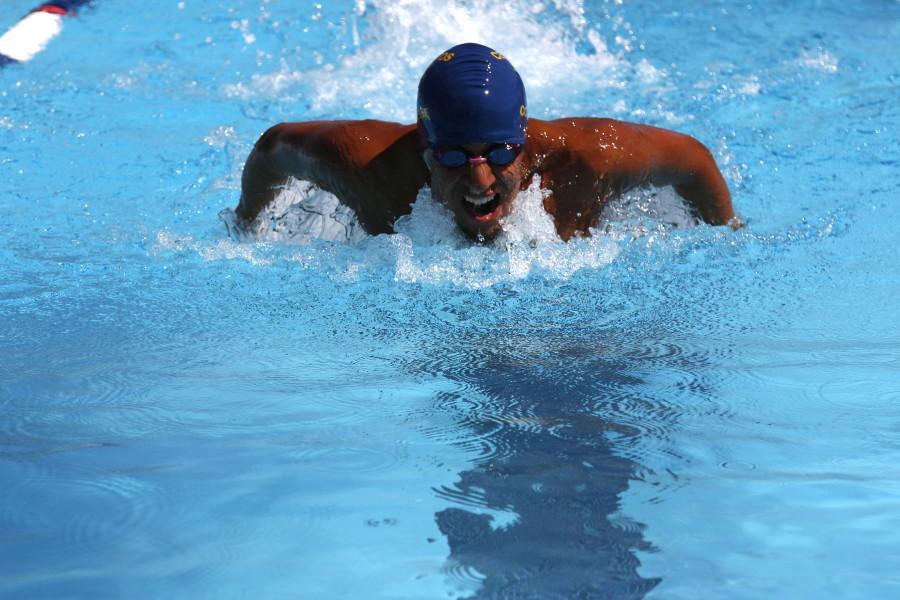 Isiah Gayton trails in second place in the 400 butterfly at a conference meet. Photo credit: Emily Curiel