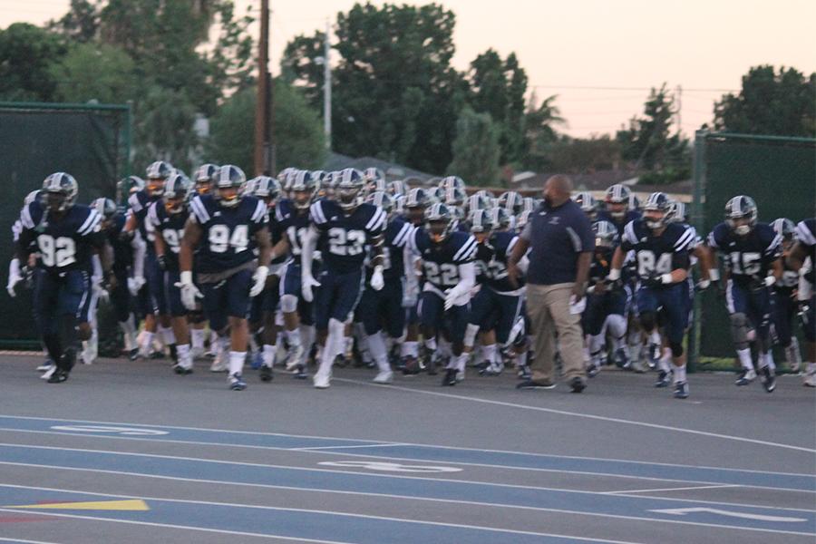 The Falcons charge onto the field at the start of the game to begin the home slate of the 2015 season. Cerritos struck first but let it slip away in the second half. Photo credit: Taylor Ogata