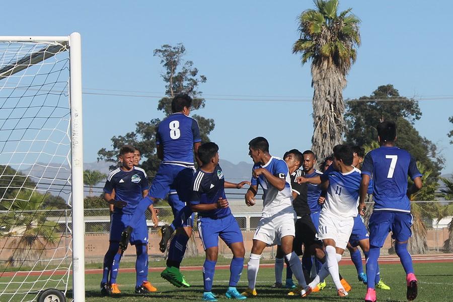 Looks like Cerritos' boys (white) are getting nice and cozy with the opponents as they get ready for a corner kick. Photo credit: Monique Nethington