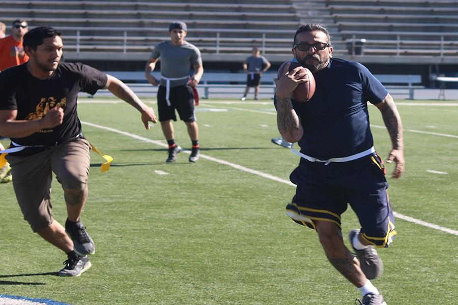 The first ever faculty and staff versus students flag football game was held at Falcon Stadium on Friday, Nov. 20. Politcal Science professor Dennis Falcon was on of the faculty members that participated in the event. Falcon(right) runs away from the the defending student(left) to try to get a first down for his team. Photo credit: Grester Celis-Acosta