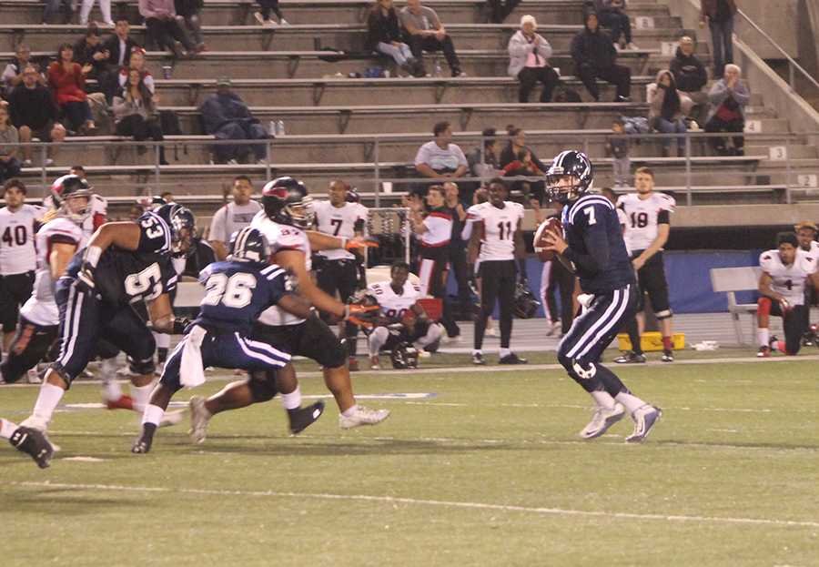 Jimmy Walker (#7) drops back to pass. Walker connected on eight of 23 passes for 134 yards and threw a touchdown as well as three interceptions on the night.