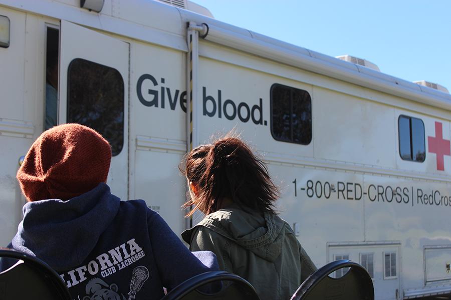 Keely Golden [left] and Ameline Villalobos [right] wait in line outside the Red Cross vehicle to donate blood Monday, Nov 16. Golden feels that by her friend living through a car accident, she has to donate blood to give back. Photo credit: Sebastian Echeverry