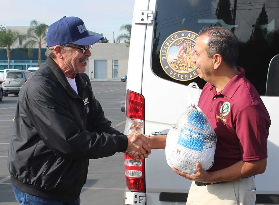 State senator Tony Mendoza greets a community member at Operation Gobble. This is Mendozas first year participating in the event as a senator. Photo credit: Gustavo Lopez