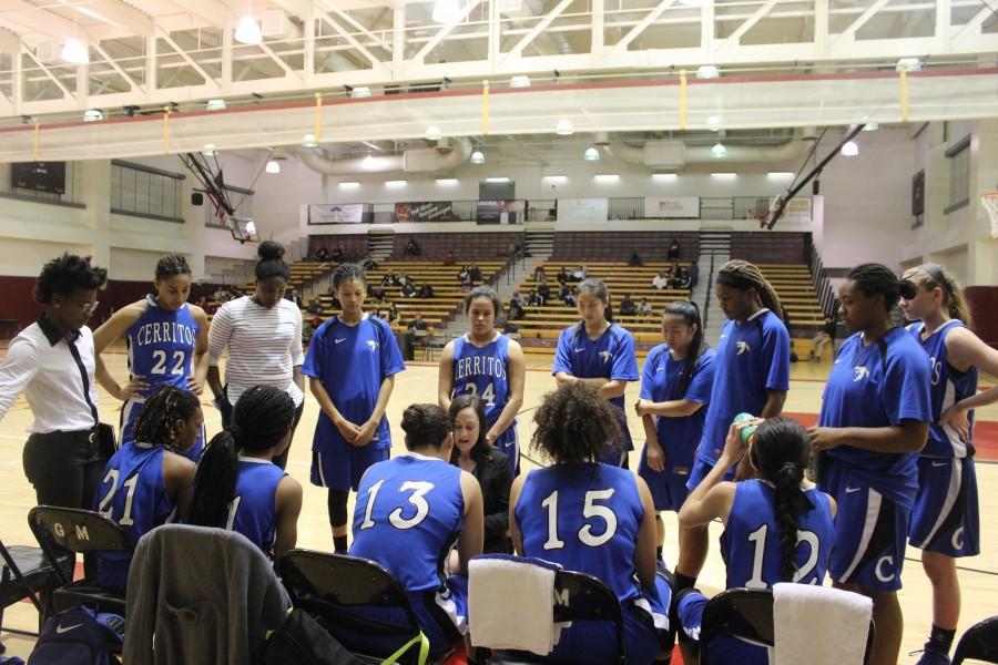 Head Coach Trisha Raniewicz (middle of huddle) draws up a play for her team during a timeout. The Lady Falcons came out of the timeout shooting the lights out from behind the arc.