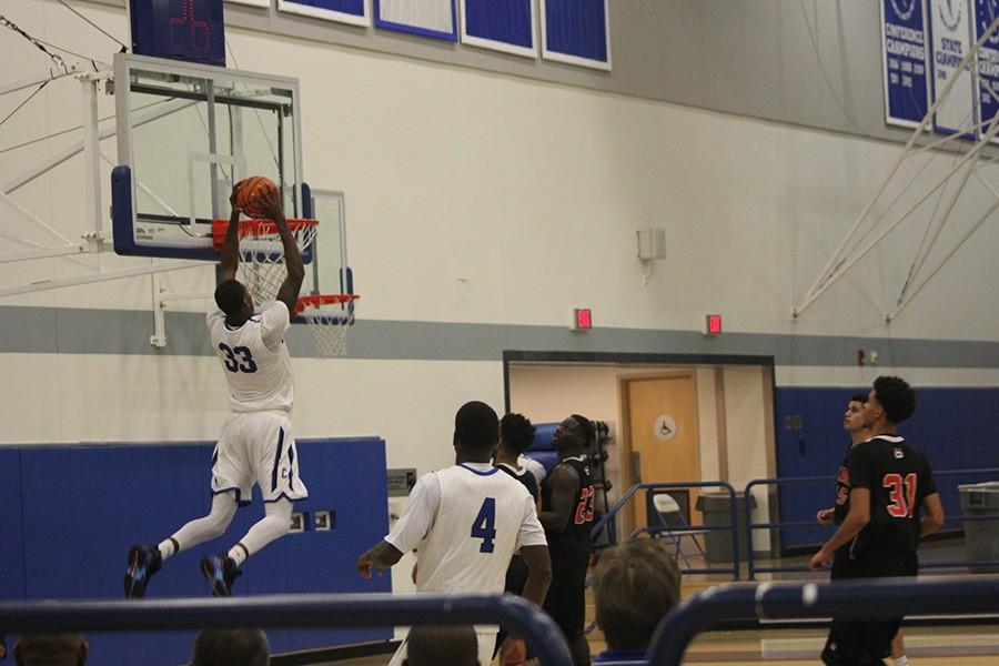 Jamal Watson takes an alley-oop lob from Khalid Washington (not pictured) and throws it down with two hands. Watson had 11 points and four rebounds on the night. Photo credit: Taylor Ogata