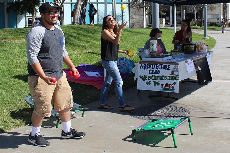 Architecture and technology club members, Jesse Magellan (left) and Krisandra Perez (right), set up a game for their fundraiser. Funds raised from the fundraiser will go towards an event for the students. Photo credit: Briana Hicks