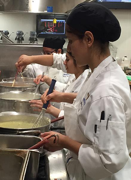 Stephanie Ruiz assists her classmates by helping them prepare the food for the culinary arts restaurant. Ruiz credits her parents as the reason why she decided to become a chef. Photo credit: Monique Nethington
