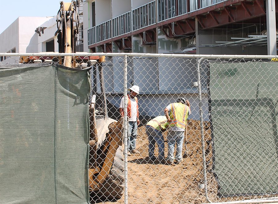Construction workers work overtime to finish the new Fine Arts Building, which is expected to open in Jan. 2017. Originally the unveilment date was projected to be ready sometime in 2018. The increased work hours to finish the building a year earlier has been reported that it is not coming from the district. Photo credit: Chantal Romero