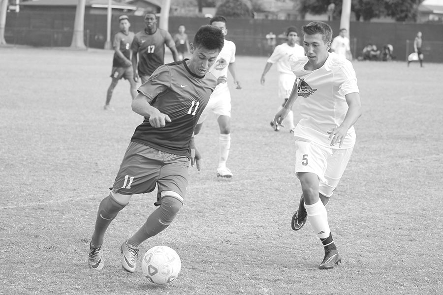 Midfielder Edwin Corona works his way through an Oxnard defensive player during Tuesdays game. The game would end with a 2-2 score