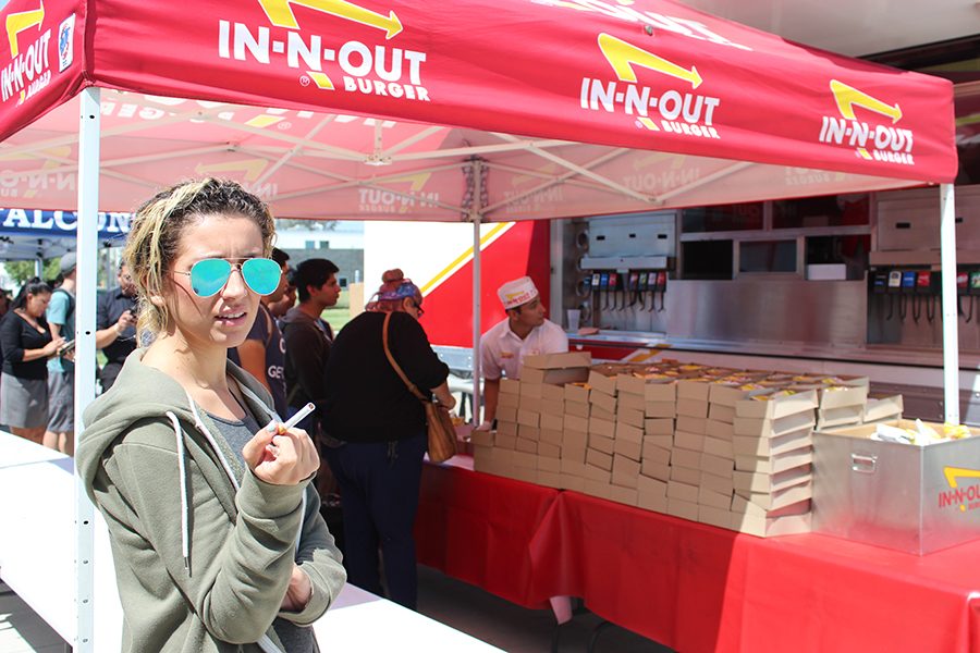 Monique Nethington (journalism major) looking at the In N Out truck and smoking. There needs to be a taco truck on campus. Photo credit: Benjamin Garcia