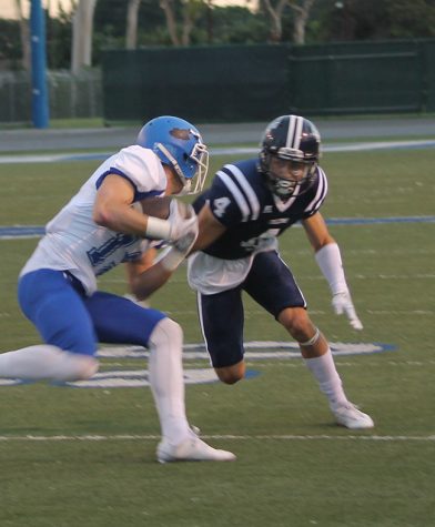 Cornerback Brandon Ezell lines up Conor McMahan of Santa Monica for a big hit. Ezell ended the night with one tackle and two interceptions.