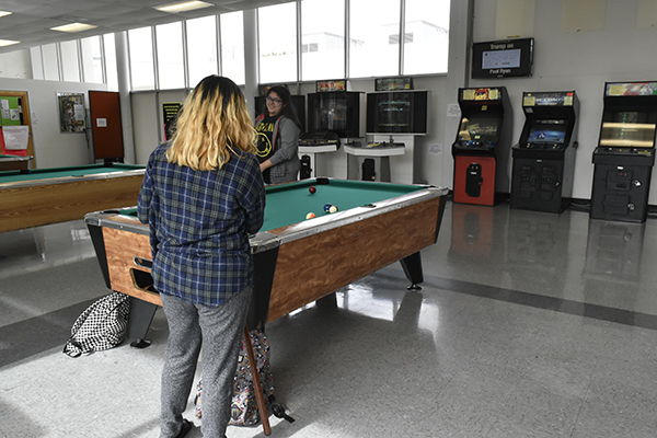 Biology major Jasmine Ortega (left) and nursing major Fabiola Nepomuceno (right)playing billiards in the game room on Thursday Oct. 29. Both Ortega and Nepomuceno visit the game room once a day and are looking forward to the changes to the game room a budget of $150,000 can make. Photo credit: Perla Lara
