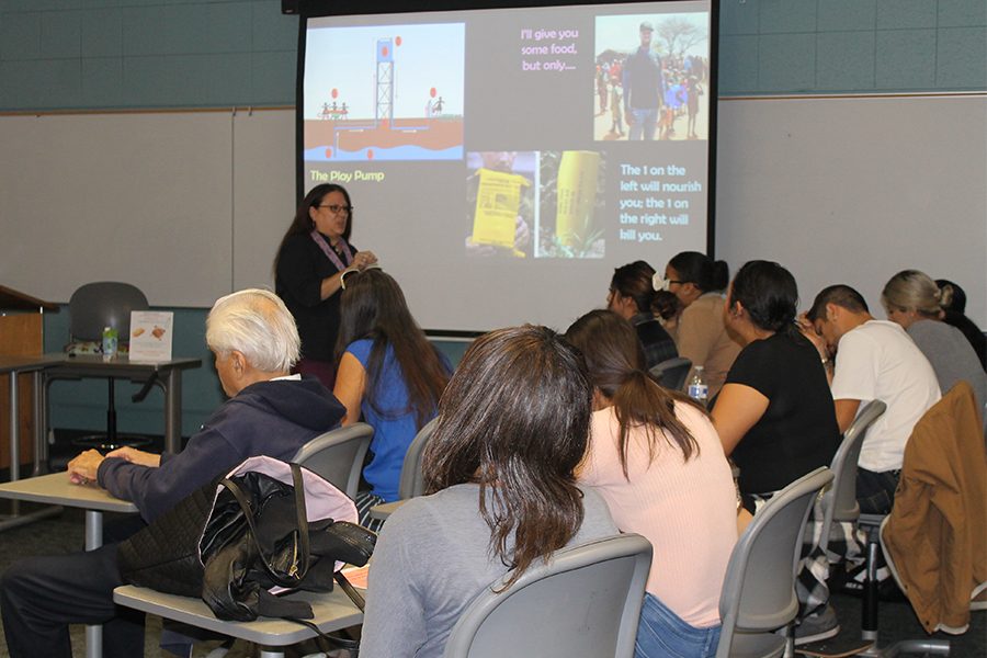 Compassion In Action club advisor Kim Berling introducing the concept of Effective Altruism and the C.I.A club during the Philosophy club meeting on Tuesday Nov. 15. The 36 students and faculty in attendance were became familiarized with the concept of EA changing people’s lives through long term solutions and not immediate temporary relief aid. Photo credit: Perla Lara