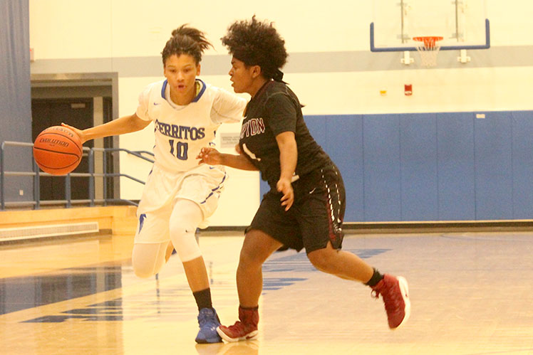 Sophomore guard Kaylyn James blows by EC-Compton defender. James would lead her team with 20 points to a victory against EC-Compton.
