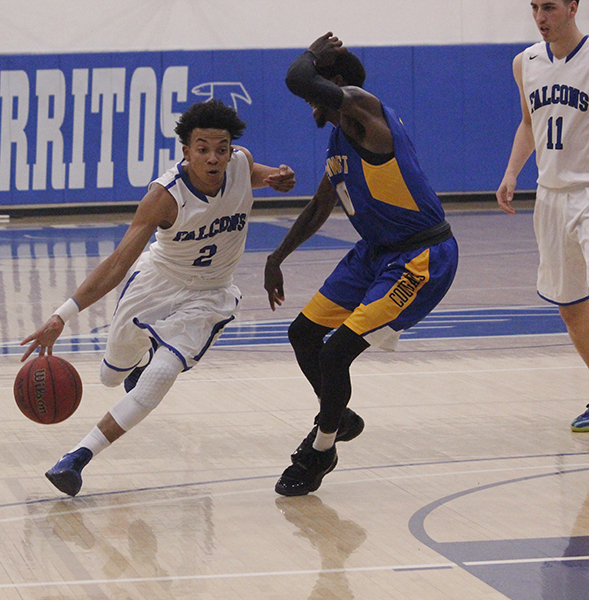 Guard Malik Smith drives past LA Southwest defender on his way to the basket. Smith would play 27 minutes in the Falcons 65-63 victory over Southwest. Photo credit: Monique Nethington