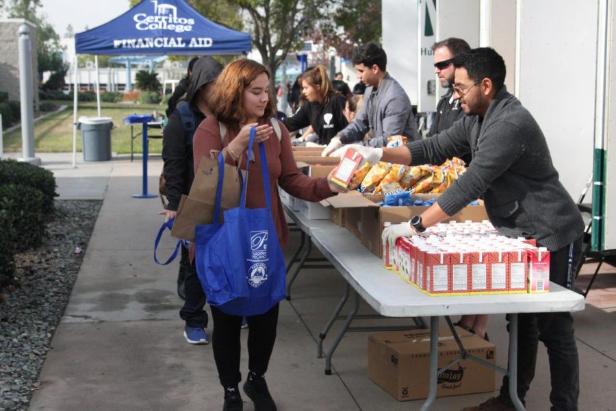 Psychology+major%2C+Diana+Salazar+taking+part+of+the+Los+Angeles+Regional+Food+Bank+that+took+place+Tuesday.+She+was+one+of+the+350+students+that+was+handed+a+Cream+of+Chicken+Soup+by+mechanical+engineer+major+Joshua+Ramos.