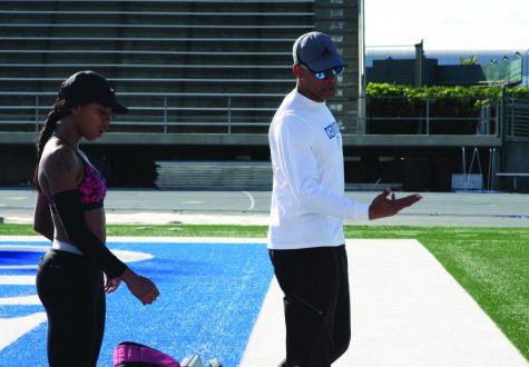 Track team member Juanita Webster and track and field coach Christopher Richardson train for upcoming track meets. Richardson, also a faculty senate member, works to have resources specific for student athletes reinstated. 