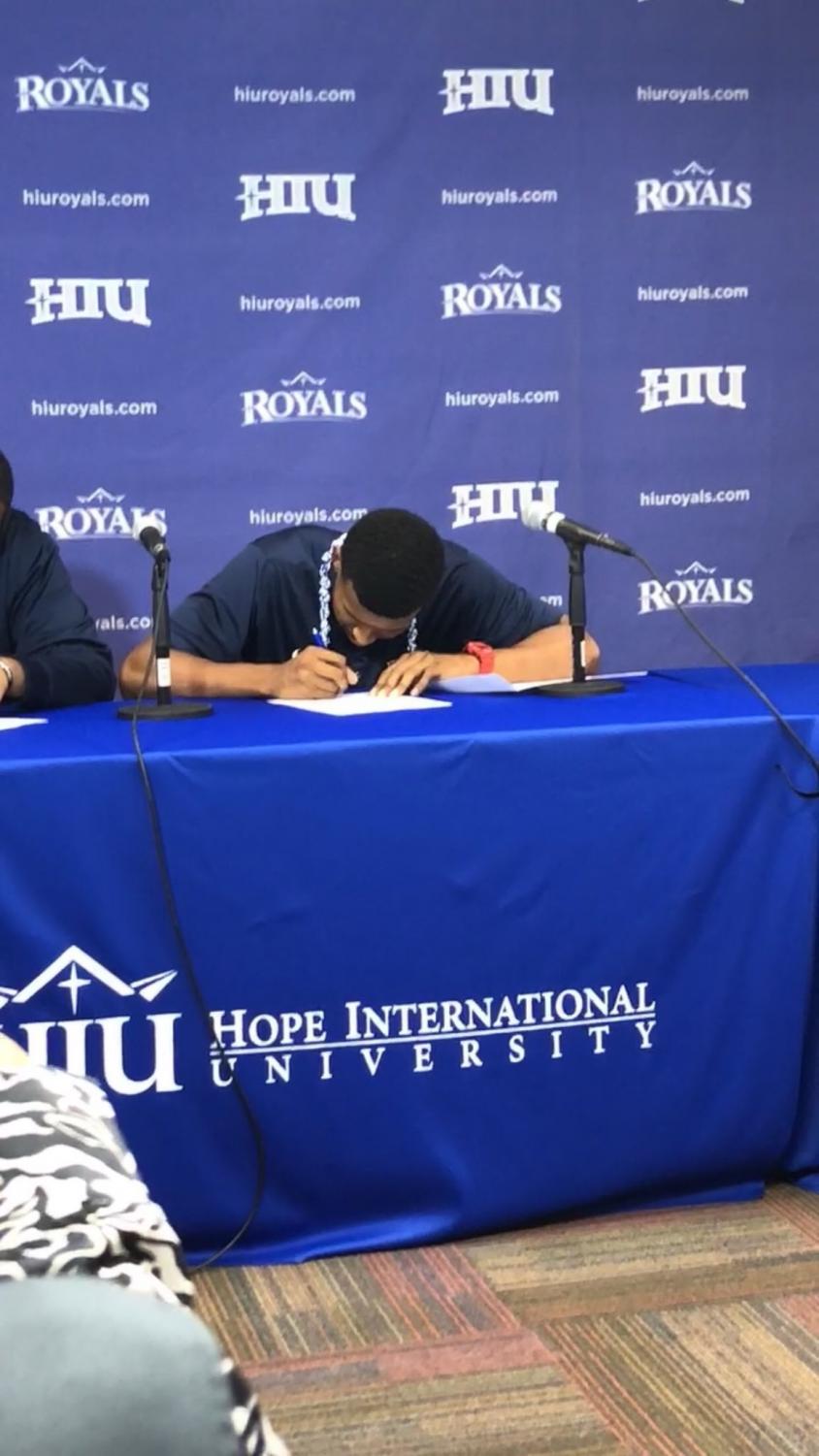 Forward Jonathan Guzman signing a national letter of intent to Hope International University. He will be receiving a two-year scholarship to attend the program. Photo credit: Malik Smith