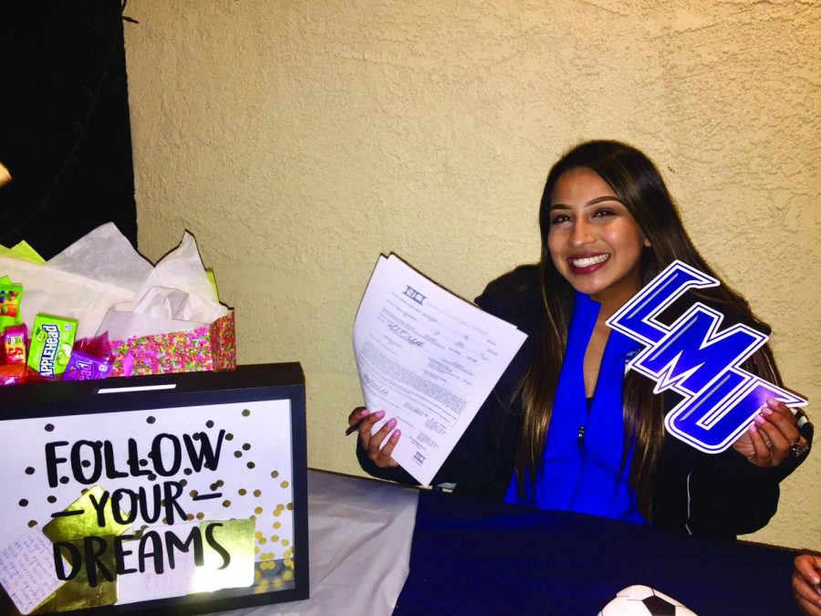 All-American soccer player, Itzel Ballesteros holds up her letter of intent to Lincoln Memorial University. The former Falcon will hang her cleats in Tennessee for two years.