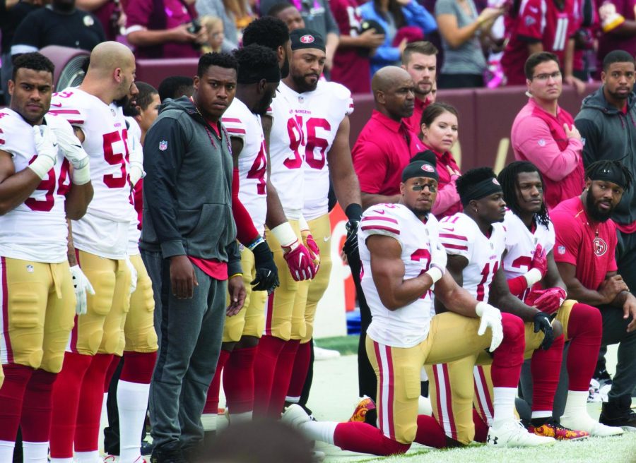 Some members of the San Francisco 49ers kneel during the National Anthem before a game against the Washington Redskins at FedEx Field on October 15, 2017 in Landover, Maryland. Photo credit: Keith Allison Creative Commons