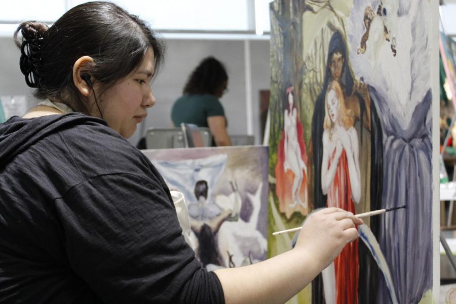Lisa Naranjo, art major, works on a painting that is part of a series of paintings depicting abuse, relationships, over-sexualization and liberation of women.