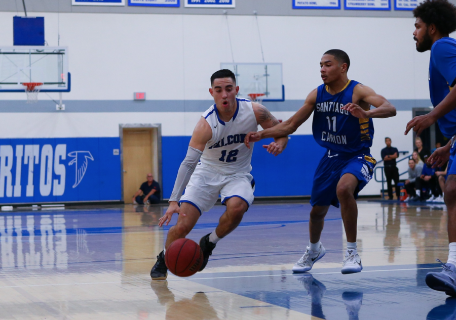 Sophomore guard Christian-Alvis Labadie drives the ball to the basket against a Santiago Canyon College defender in the Southern California Regional Final at Cerritos College on March 3, 2018. The 2018-19 Falcons team are 7-1 on the young season, as the  team seeks a consecutive Final Four berth.
Photo courtesy of Daryl Peterson/Cerritos Sports Information