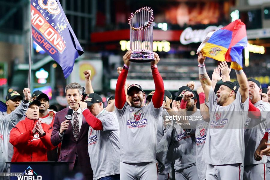 HOUSTON, TEXAS - OCTOBER 30: Manager Dave Martinez #4 of the Washington Nationals hoists the Commissioners Trophy after defeating the Houston Astros 6-2 in Game Seven to win the 2019 World Series in Game Seven of the 2019 World Series at Minute Maid Park on October 30, 2019 in Houston, Texas