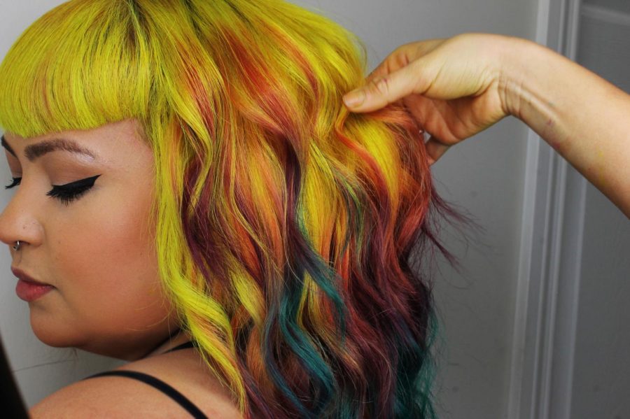 Grajeda makes sure that every color is captured when her client models their new do. Photo credit: Rebecca Aguila