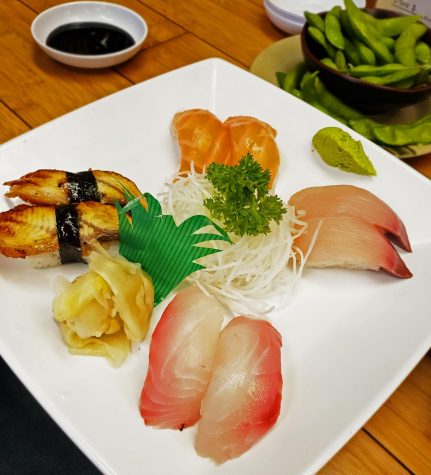 Sashimi Plate featuring Salmon, unagi (eel) Red Snapper and yellow tail. A plate this delicate yet full of delicious savory flavors along side edamame beans.