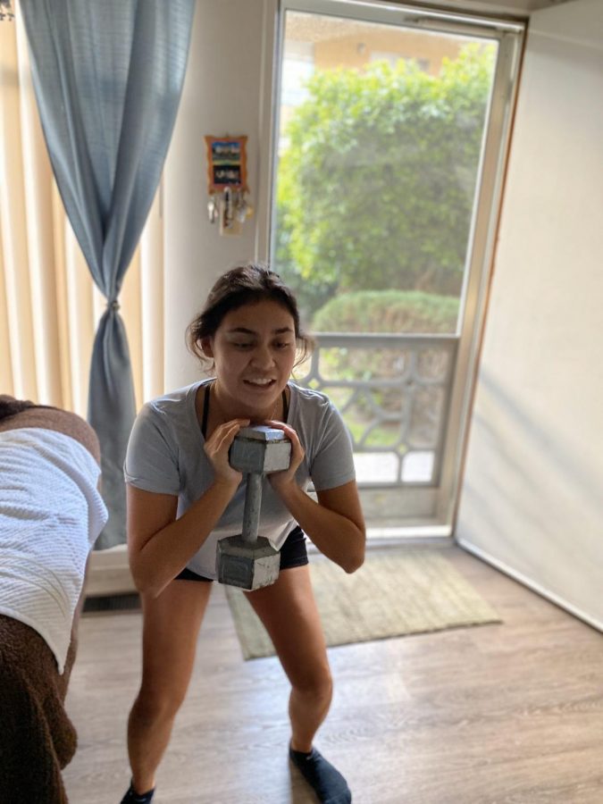 Karina Oliveros working out at home to stay in shape for the upcoming water polo season.