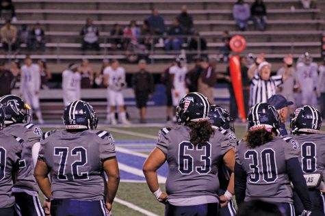 Cerritos College football team members watch the action from the sidelines. They wait for their opportunity to get back on the field Nov. 2, 2019 