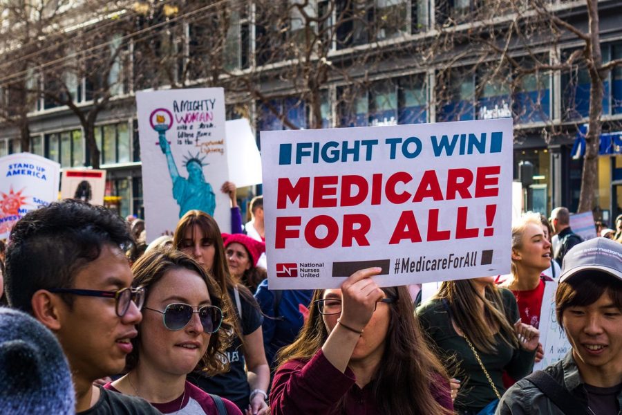 A woman at the Womens March holds Medicare for all sign while marching on Market street in downtown San Francisco. (Dreamstime/TNS)