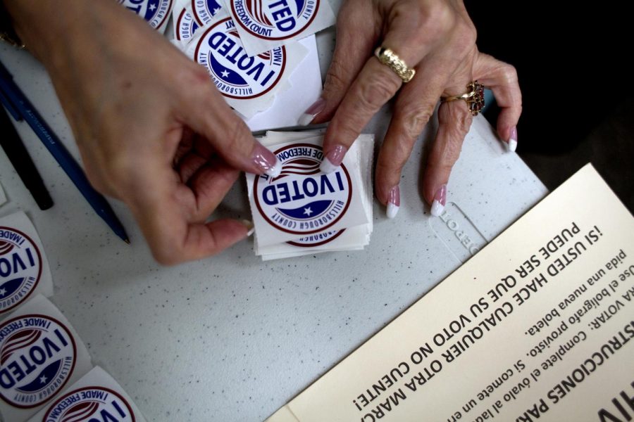 A poll worker gets I Voted stickers ready to hand to voters as they finished up at the ballot booths at Jan Kaminis Platt Regional Library in South Tampa, Fla., on November 6, 2012. (Carolina Hidalgo/Tampa Bay Times/TNS)