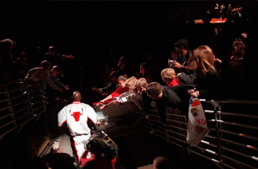 In this file photo, with fans reaching for a touch, Michael Jordan steps into the spotlight as he's introduced for the Bulls' 5th NBA Championships ring ceremony on Nov. 1, 1997, at the United Center. ESPN recently relased a 10-part-series, 