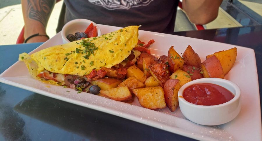 A buttery omelet filled with 5+ toppings garnished with dried parsley flakes. Eat This cafe is worth the drive on the 101 freeway.